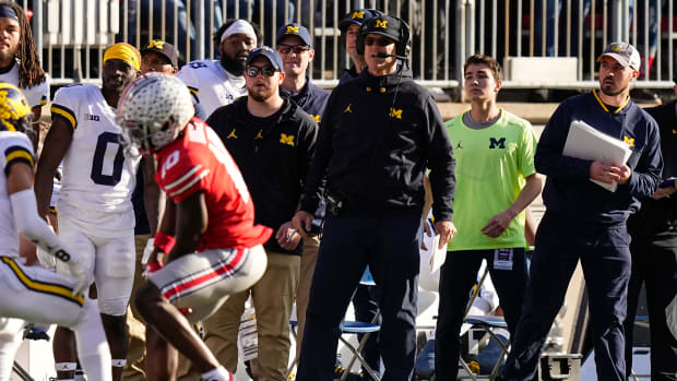 Michigan Wolverines head coach Jim Harbaugh watches from the sideline beside off-field analyst Connor Stalions, right, during the NCAA football game against the Ohio State Buckeyes at Ohio Stadium